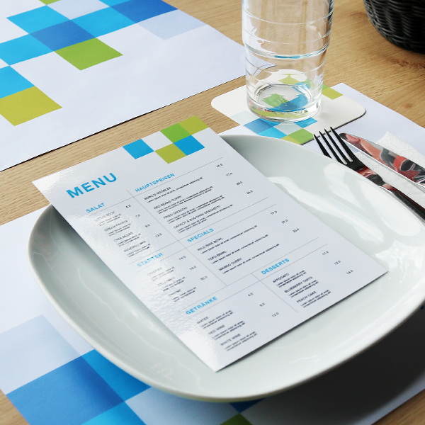 Unfolded menu placed on a plate in a restaurant